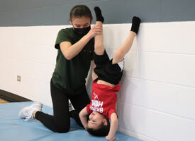 boy learning to do a headstand