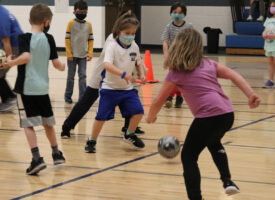kids playing soccer in gym