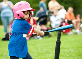 girl playing t-ball