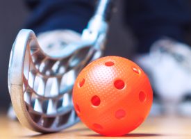 floor hockey image of ball and stick