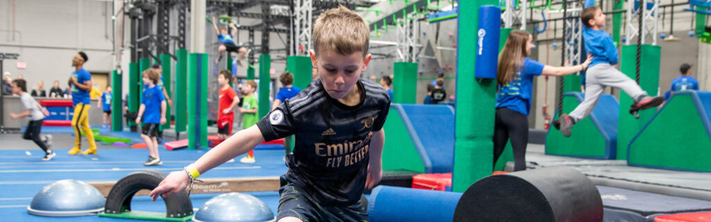 Boy running obstacle course