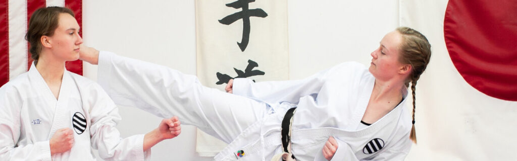 Two teen girls sparring in Karate