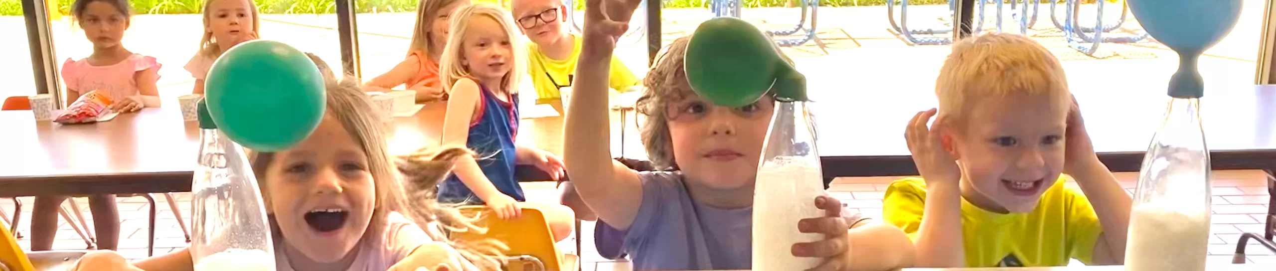 Three preschoolers with balloon experiment